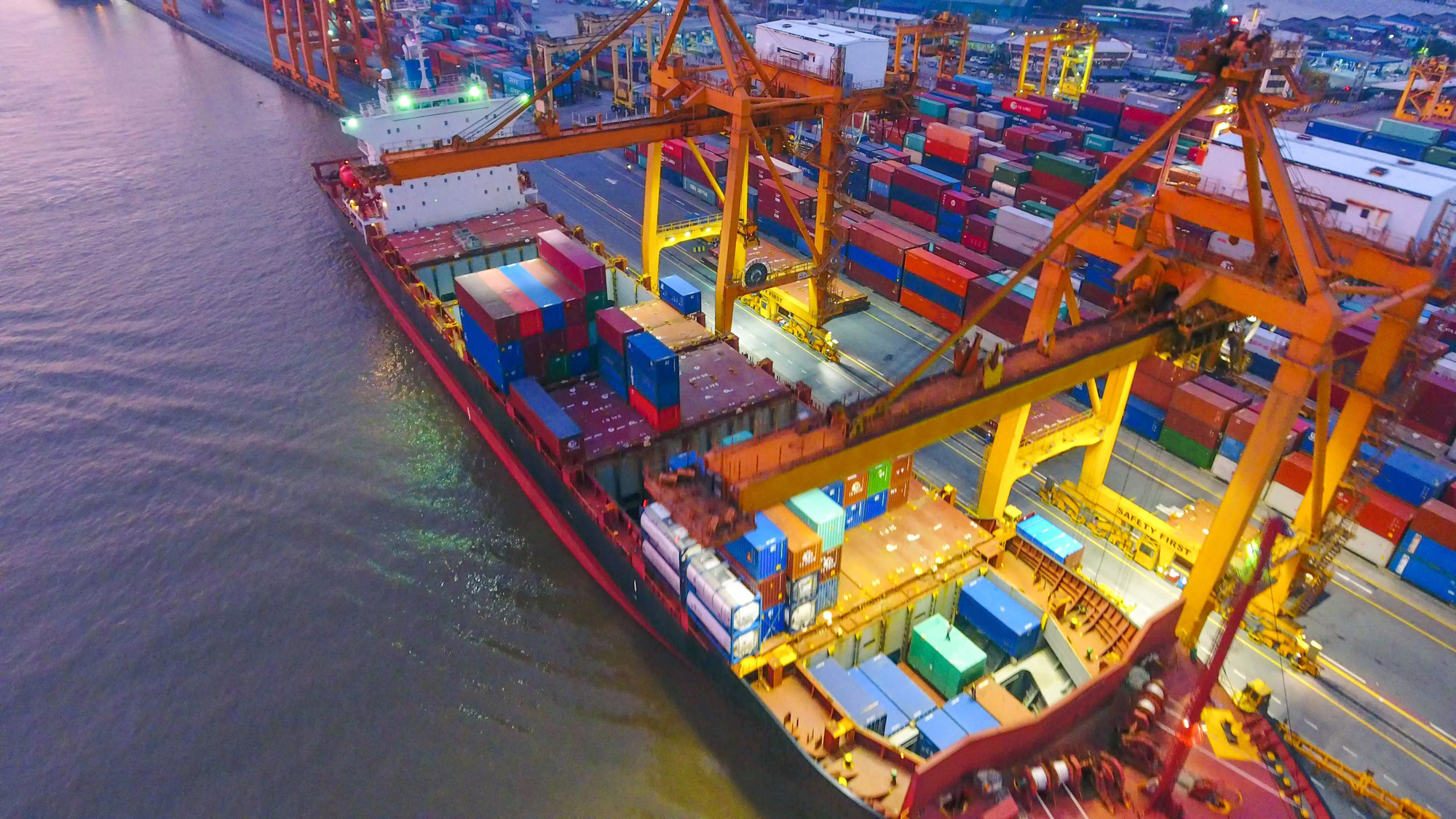 Logistics and transportation of Container Cargo ship and Cargo working crane bridge in shipyard